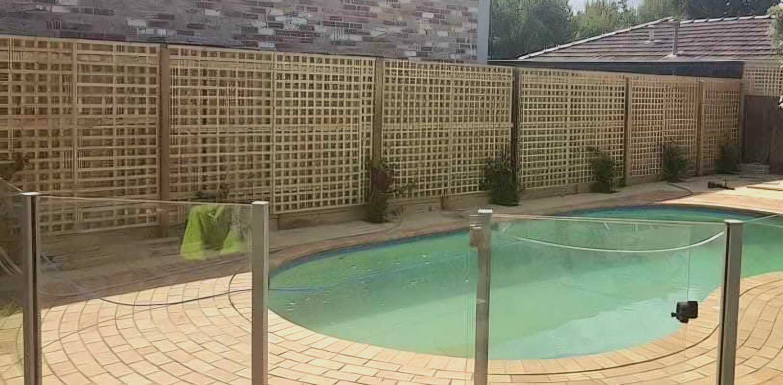 Timber lattice boundary fence around a pool area